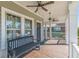 Charming front porch with a dark bench, stylish ceiling fans, and a paneled door at 1763 Mercer Ave, Atlanta, GA 30337