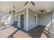 Cozy front porch includes ceiling fans, bench seating, and a paneled front door at 1763 Mercer Ave, Atlanta, GA 30337