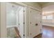 Bright hallway with hardwood floors, closet, and entry to another room at 1763 Mercer Ave, Atlanta, GA 30337
