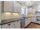 Kitchen showcasing stainless steel appliances, white subway tile, and granite countertops at 1763 Mercer Ave, Atlanta, GA 30337