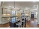 Open kitchen with stainless steel appliances, center island, and white cabinets and granite counters at 1763 Mercer Ave, Atlanta, GA 30337