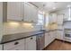 Modern kitchen with white cabinets, subway tile backsplash, and stainless steel appliances at 1763 Mercer Ave, Atlanta, GA 30337