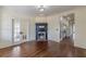 Living room with hardwood floors, decorative fireplace, french doors, and entrance to hallway at 1763 Mercer Ave, Atlanta, GA 30337