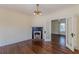 Spacious living room with vintage lighting fixture, fireplace, and french doors to another room at 1763 Mercer Ave, Atlanta, GA 30337