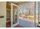 A view of the wooden patio from the inside, through glass doors and a small doorway at 1763 Mercer Ave, Atlanta, GA 30337