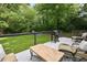 View of back deck with a grill, dining table and chairs overlooking the lawn at 3314 Creatwood Se Trl, Smyrna, GA 30080