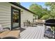 Cozy back deck with a gas grill, a lounge and chairs for outdoor relaxation and entertaining at 3314 Creatwood Se Trl, Smyrna, GA 30080
