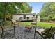 Landscaped backyard with outdoor seating, fire pit and well manicured lawn at 3314 Creatwood Se Trl, Smyrna, GA 30080