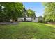 Spacious backyard featuring a manicured lawn, fire pit, and a cozy back deck at 3314 Creatwood Se Trl, Smyrna, GA 30080