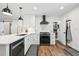 Well-equipped kitchen featuring stainless steel appliances, a modern range hood, and a practical pantry at 3314 Creatwood Se Trl, Smyrna, GA 30080