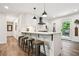 Modern kitchen with white cabinets, breakfast bar and stainless steel appliances at 3314 Creatwood Se Trl, Smyrna, GA 30080