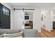 Cozy living room featuring a sliding barn door leading to the bedroom at 3314 Creatwood Se Trl, Smyrna, GA 30080