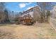 Exterior view of the home showing a wooden deck and spacious backyard at 6640 Grove Crossing Ct, Cumming, GA 30028