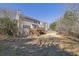 View of the backyard with a wooden deck and stairs leading to the home at 6640 Grove Crossing Ct, Cumming, GA 30028