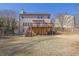 Backyard featuring a wooden deck, a home exterior, and mature trees at 6640 Grove Crossing Ct, Cumming, GA 30028