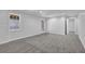 Finished basement area with neutral walls and plush grey carpeting at 6640 Grove Crossing Ct, Cumming, GA 30028