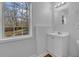 Bright bathroom features a white vanity, wood flooring, and backyard views at 6640 Grove Crossing Ct, Cumming, GA 30028