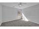 Bright bedroom with carpet floors and ample light from the single window at 6640 Grove Crossing Ct, Cumming, GA 30028