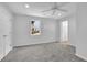 Bright bedroom features plush carpeting, ceiling fan, and a well-lit interior at 6640 Grove Crossing Ct, Cumming, GA 30028