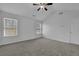 Bright bedroom with ample natural light from windows and a ceiling fan, perfect for relaxation and comfort at 6640 Grove Crossing Ct, Cumming, GA 30028