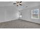 Spacious bedroom with vaulted ceiling, large windows, and neutral carpet, creating a bright and inviting atmosphere at 6640 Grove Crossing Ct, Cumming, GA 30028