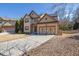 Attractive home showcasing a two-car garage, well-manicured lawn, and a welcoming entrance at 6640 Grove Crossing Ct, Cumming, GA 30028