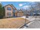 Inviting home with two-car garage, green lawn and traditional design at 6640 Grove Crossing Ct, Cumming, GA 30028