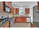 Functional kitchen with stainless steel appliances, granite countertops, and tiled backsplash at 6640 Grove Crossing Ct, Cumming, GA 30028