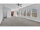 Open-concept living space with kitchen access and large windows for natural light at 6640 Grove Crossing Ct, Cumming, GA 30028