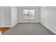 Bright living room with neutral carpet, chair rail, and ample natural light at 6640 Grove Crossing Ct, Cumming, GA 30028