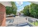 A balcony view overlooking a parking area and green space in a residential community at 1352 Orchard Park Dr, Stone Mountain, GA 30083