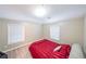 Bedroom with two windows and a red bed spread is well lit from above at 1352 Orchard Park Dr, Stone Mountain, GA 30083