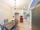 Open dining area with modern chandelier flows into kitchen and office space at 1352 Orchard Park Dr, Stone Mountain, GA 30083
