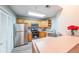 Bright kitchen featuring light wood cabinetry, stainless steel appliances, and white countertop at 1352 Orchard Park Dr, Stone Mountain, GA 30083