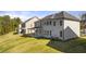 Rear exterior showing a expansive lawn area, siding, and multiple windows at 1861 Lacebark Elm Way, Lawrenceville, GA 30045