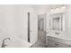 Bright bathroom featuring double sinks, modern fixtures, and tiled floors at 1861 Lacebark Elm Way, Lawrenceville, GA 30045