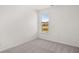 Bright, empty bedroom with neutral carpet and a large window for plenty of natural light at 1861 Lacebark Elm Way, Lawrenceville, GA 30045