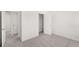 Spacious bedroom with plush carpeting, closet, and a doorway view at 1861 Lacebark Elm Way, Lawrenceville, GA 30045