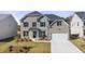 Charming two-story home with a brick facade, black shutters, and a well-manicured lawn, creating a welcoming curb appeal at 1861 Lacebark Elm Way, Lawrenceville, GA 30045