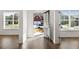 Bright foyer with hardwood floors, white walls and a black front door at 1861 Lacebark Elm Way, Lawrenceville, GA 30045