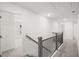 Upstairs hallway features modern railings leading to bedrooms and bathrooms at 1861 Lacebark Elm Way, Lawrenceville, GA 30045