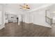 Open floor plan with wood floors leading to an eat-in kitchen featuring an island and stainless appliances at 1861 Lacebark Elm Way, Lawrenceville, GA 30045