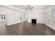 Spacious living room with fireplace, wood floors, ceiling fan, and plenty of natural light at 1861 Lacebark Elm Way, Lawrenceville, GA 30045