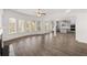 Open floor plan with wood floors, fireplace, large windows and sightlines into the kitchen at 1861 Lacebark Elm Way, Lawrenceville, GA 30045