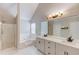 Bright bathroom features a double sink vanity with marble counters, tub, and a shower stall at 114 Farm Valley Dr, Canton, GA 30115