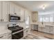 Modern kitchen featuring white cabinets, stainless steel appliances, and beautiful countertops at 114 Farm Valley Dr, Canton, GA 30115