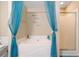 Large white soaking tub with blue decor and glass door shower at 5099 Leeshire Trce, Tucker, GA 30084