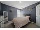 Bedroom with gray walls and bed with a quilted comforter at 5099 Leeshire Trce, Tucker, GA 30084