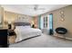 Primary bedroom with a large window, carpet flooring, ceiling fan, and natural light at 5099 Leeshire Trce, Tucker, GA 30084