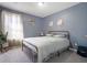 Bedroom featuring a comfortable bed, soft lighting, and decorative touches at 5099 Leeshire Trce, Tucker, GA 30084